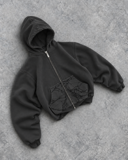 Grey Webster Ct. Zip-Up Hoodie angled view with spiderweb pocket panels