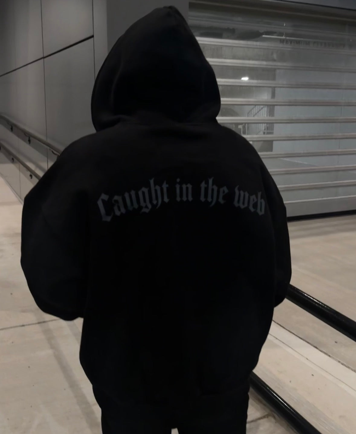 Back of the black Webster hoodie with Caught in the Web lettering