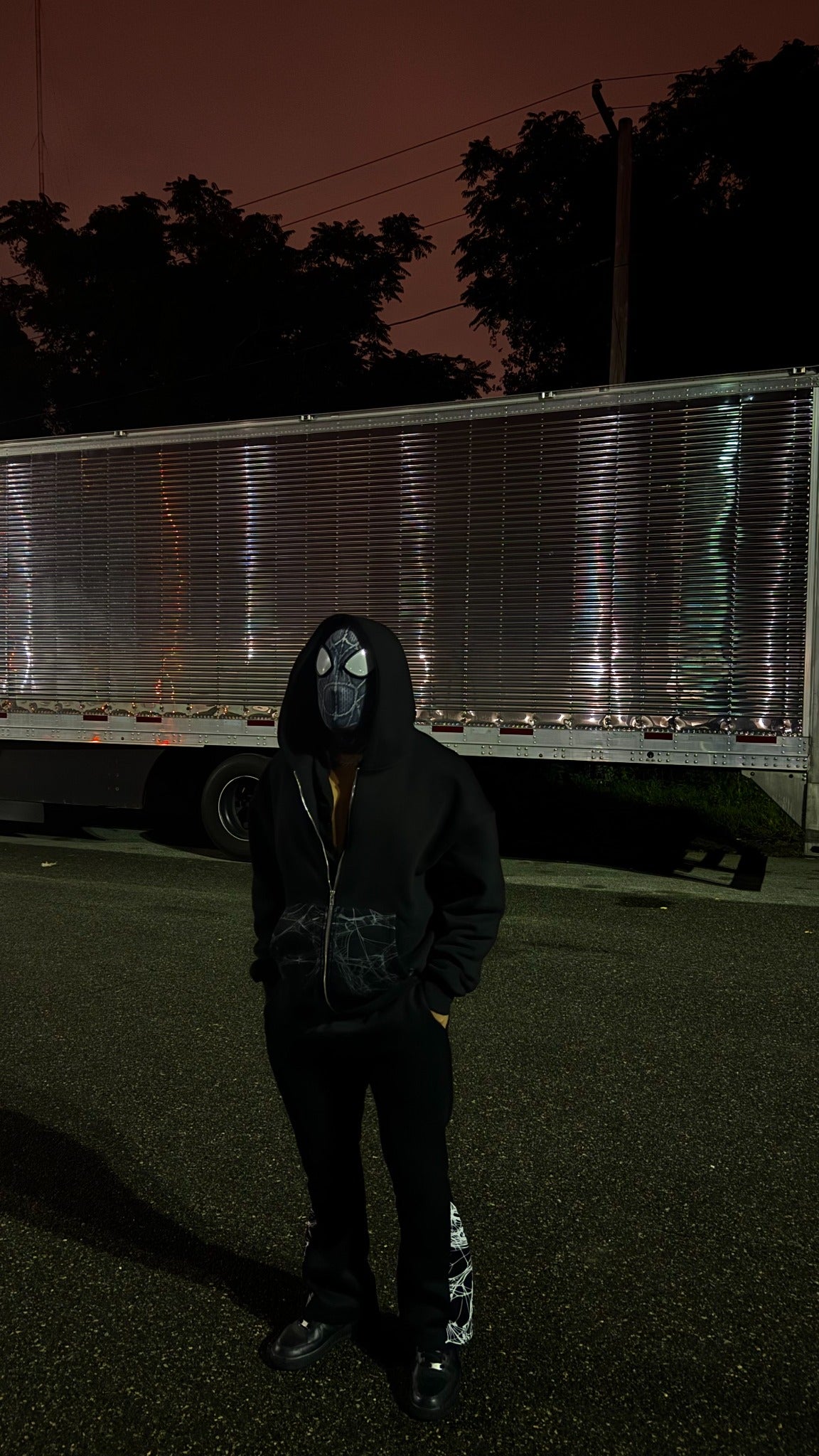 Black Webster hoodie styled on a model outdoors at night